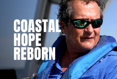 Daniel Songy on a boat with the words Coastal Hope Reborn next to him