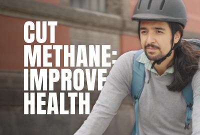 A person wearing a helmet with the words "Cut methane: Improve health" next to them