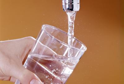 A glass of water being filled