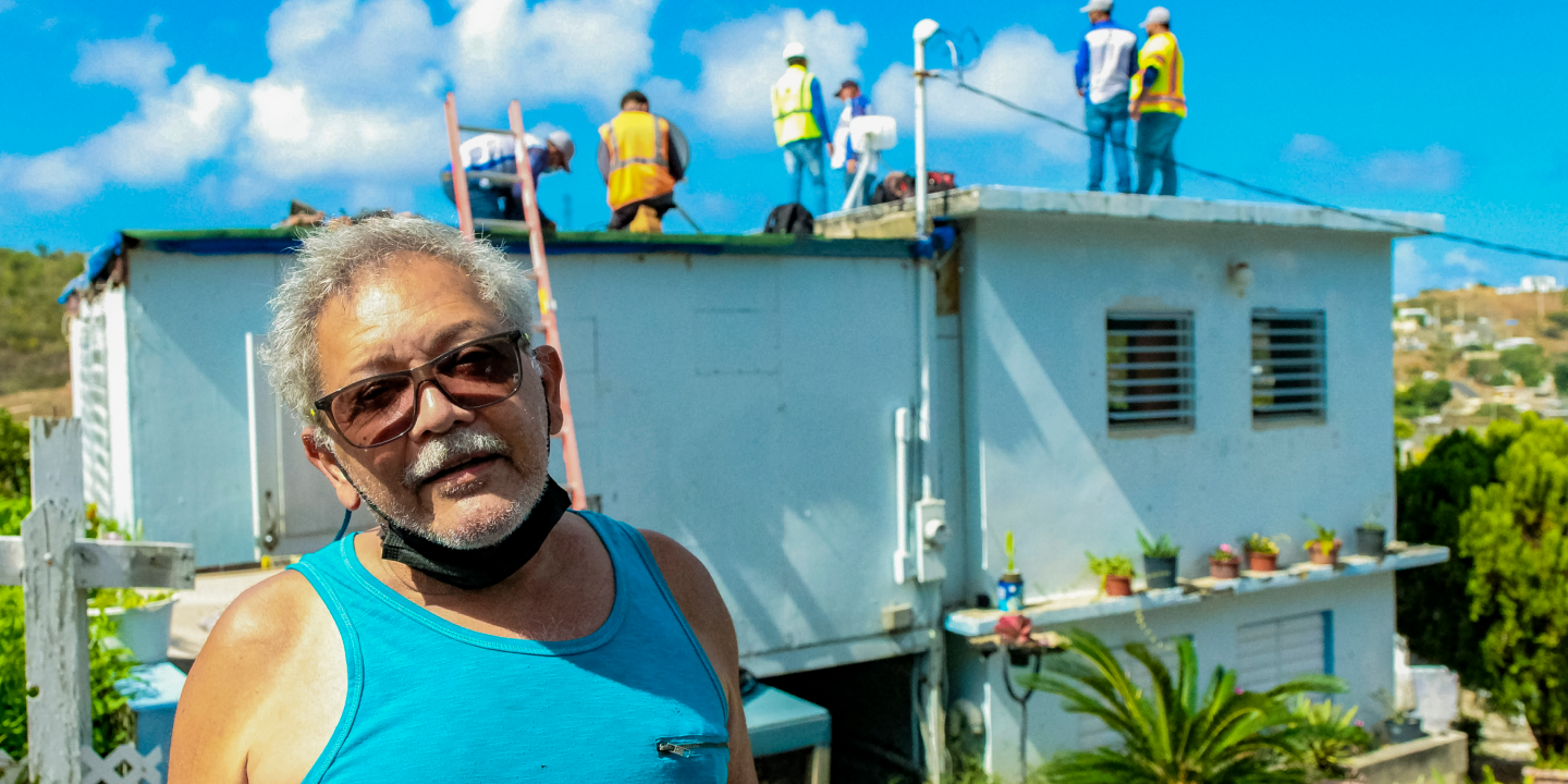 Image of a man in sunglasses and blue tank top