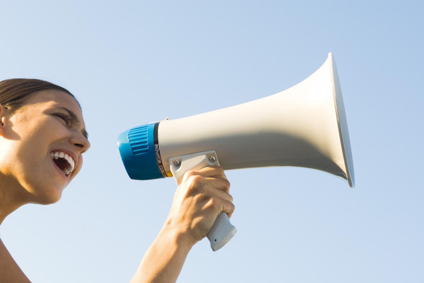 An activist shouting into a megaphone