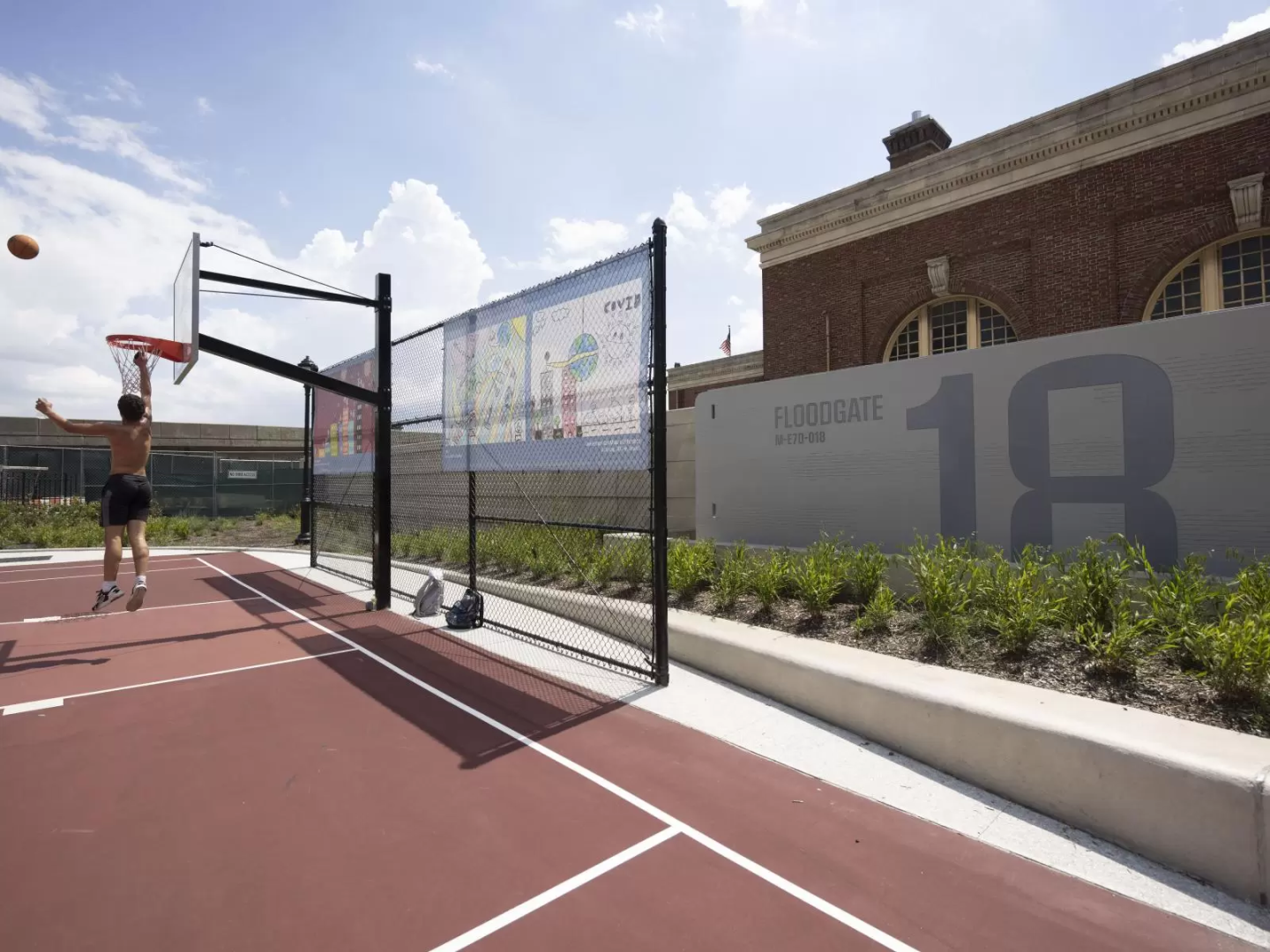 urban basketball court with floodgate #18 behind it