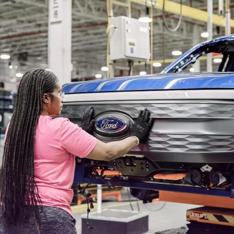 A woman assembling an EV at Ford factory