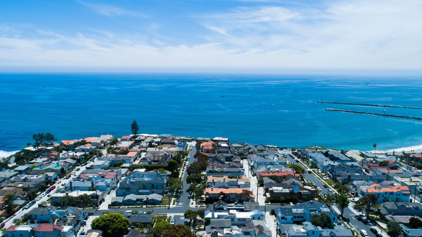 An overhead shot of a coastal town with endless blue water stretching off in the distance. Okay, obviously, not really endless, but it looks endless in the picture