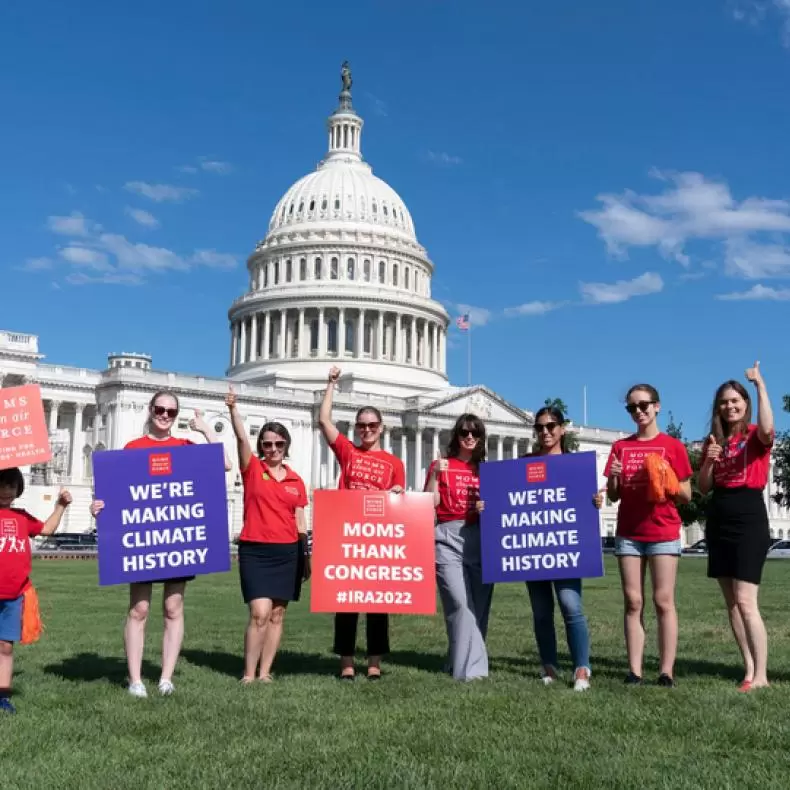 A group of moms celebrate the passage of the Inflation Reduction Act, the biggest climate bill in U.S. history.