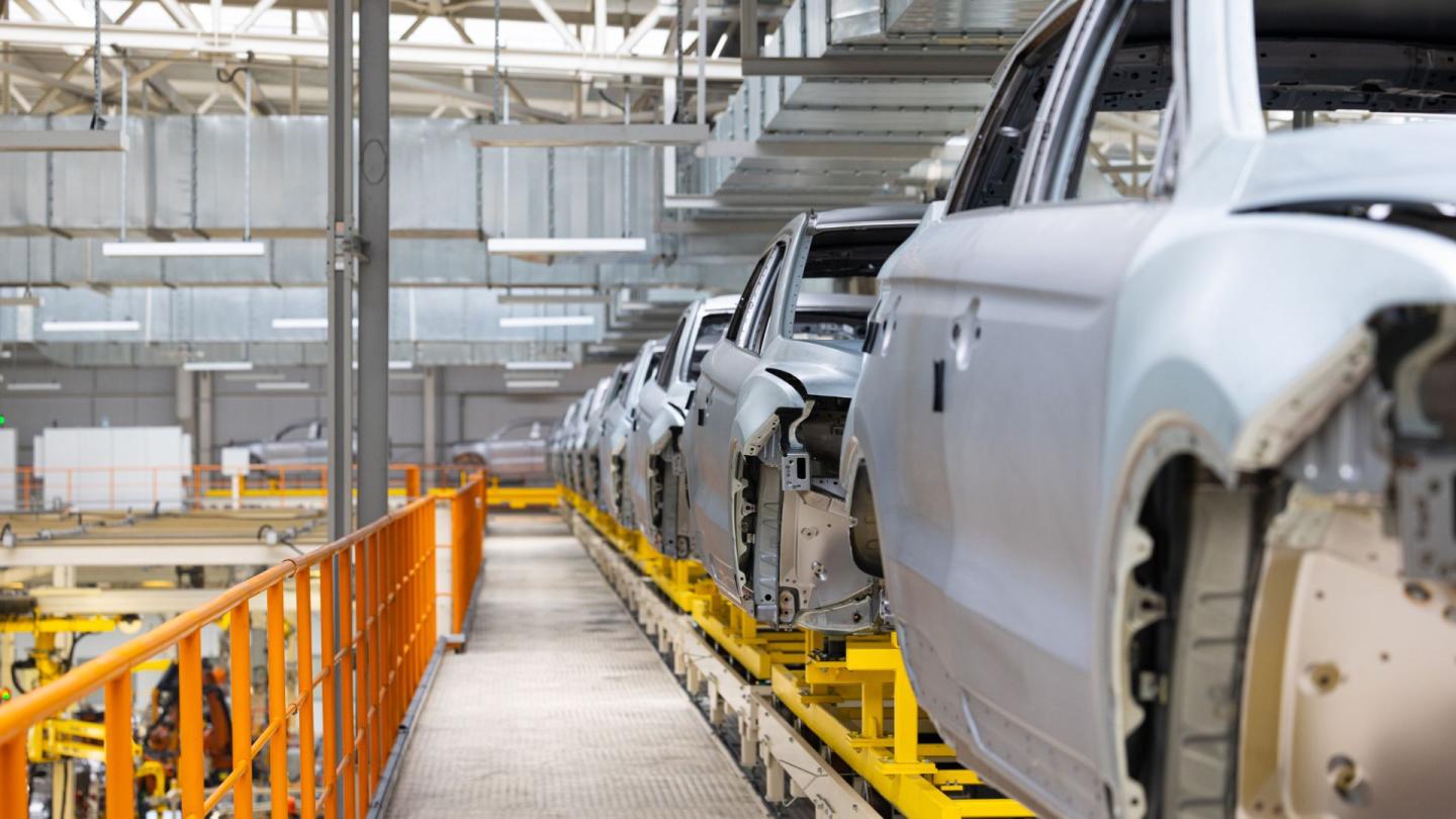 A car manufacturing line producing the bodies of unfinished cars