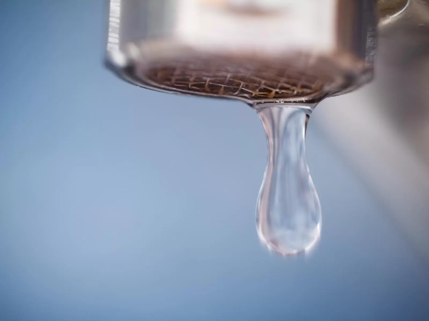 A drop of water falling out of the tap