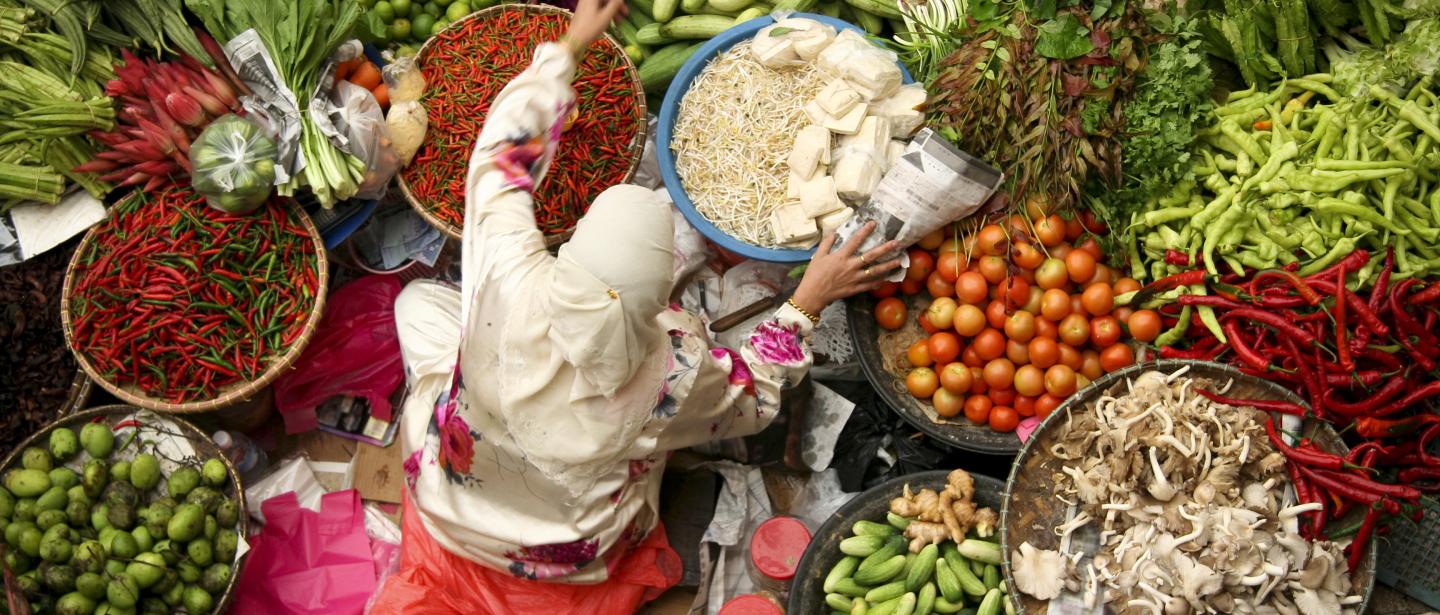 An overhead of a person sorting baskets of food