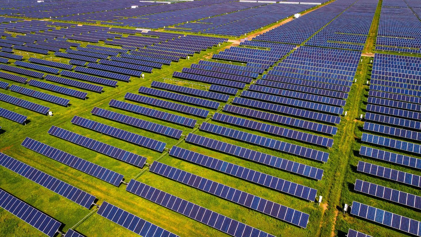 A sprawling field of solar panels as far as the eye can see