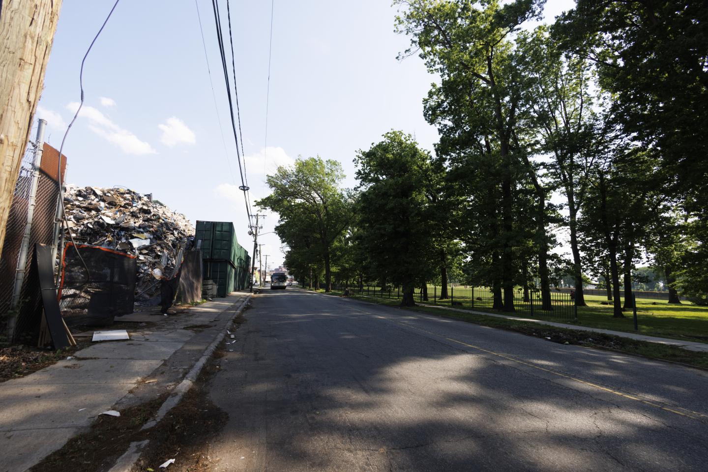 A road in Newark that separates a scrap yard on one side and a park on the other