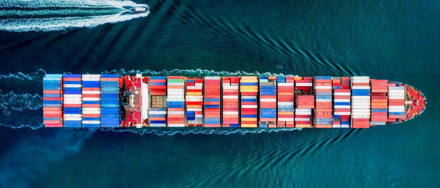 An overhead shot of a ship hauling many colorful containers 