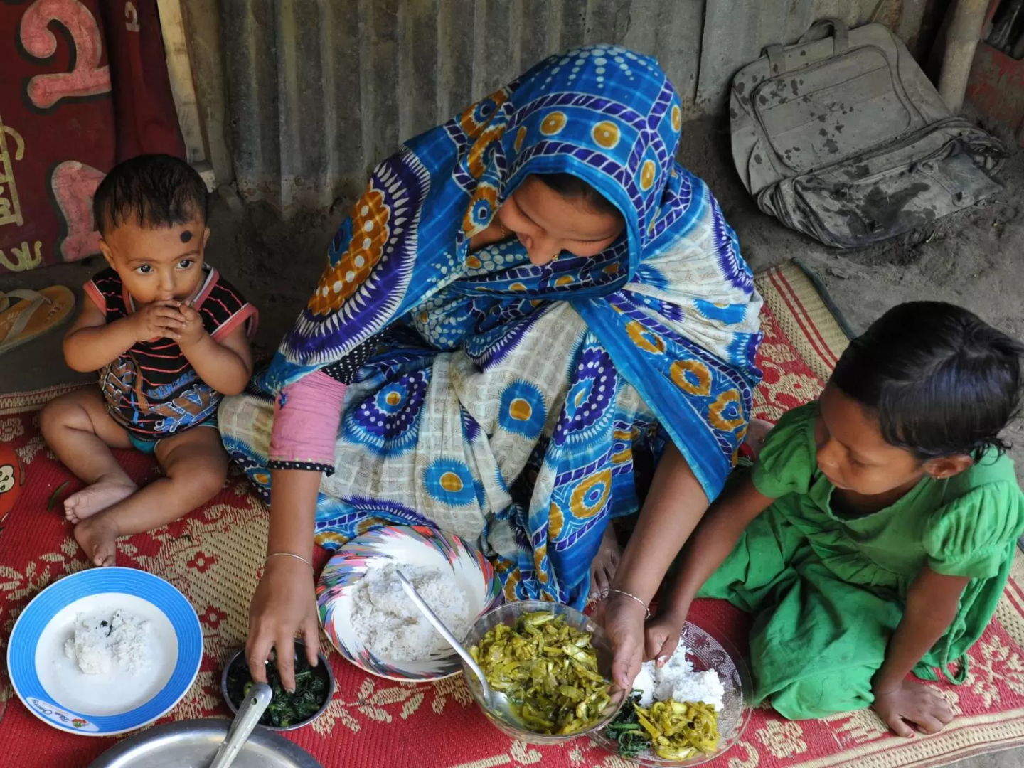 A family in Bangladesh huddles over a dinner 