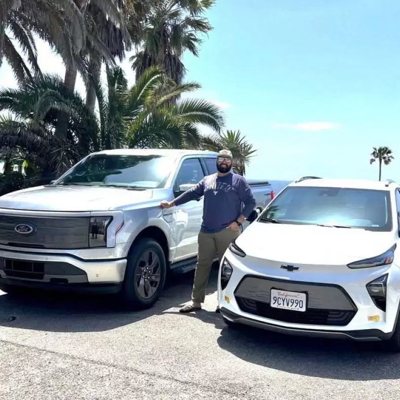 Adrian Padilla with his electric F150 and Chevy Bolt EV