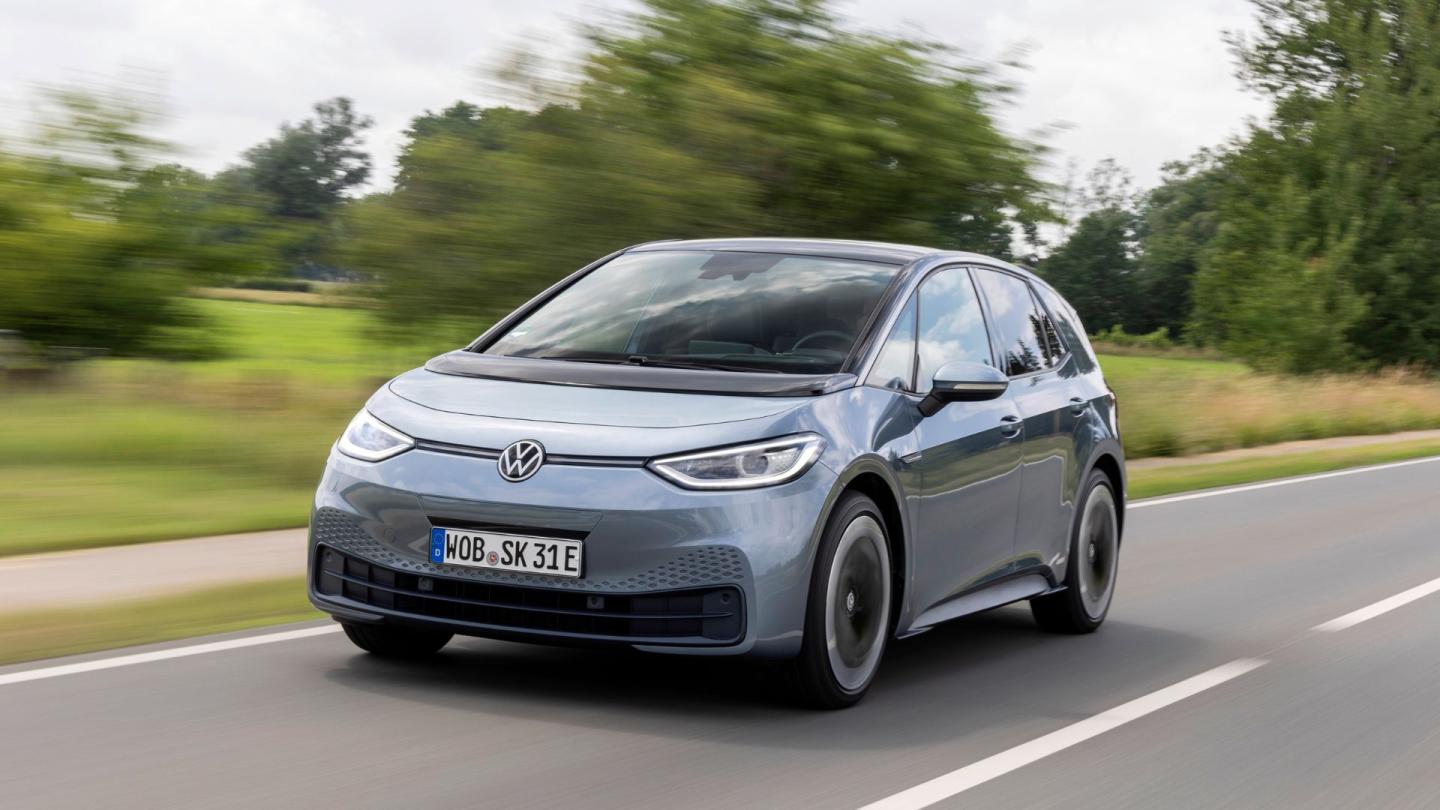 An electric Volkswagen driving down the road