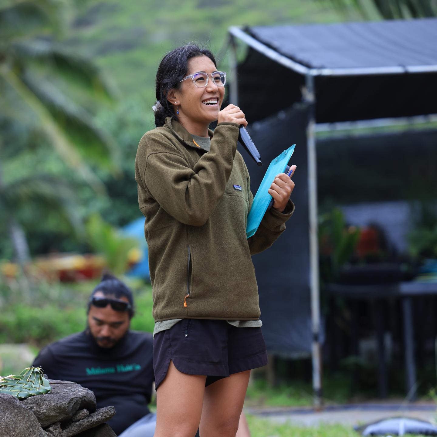 Brenda Asuncion speaking into a microphone at an event