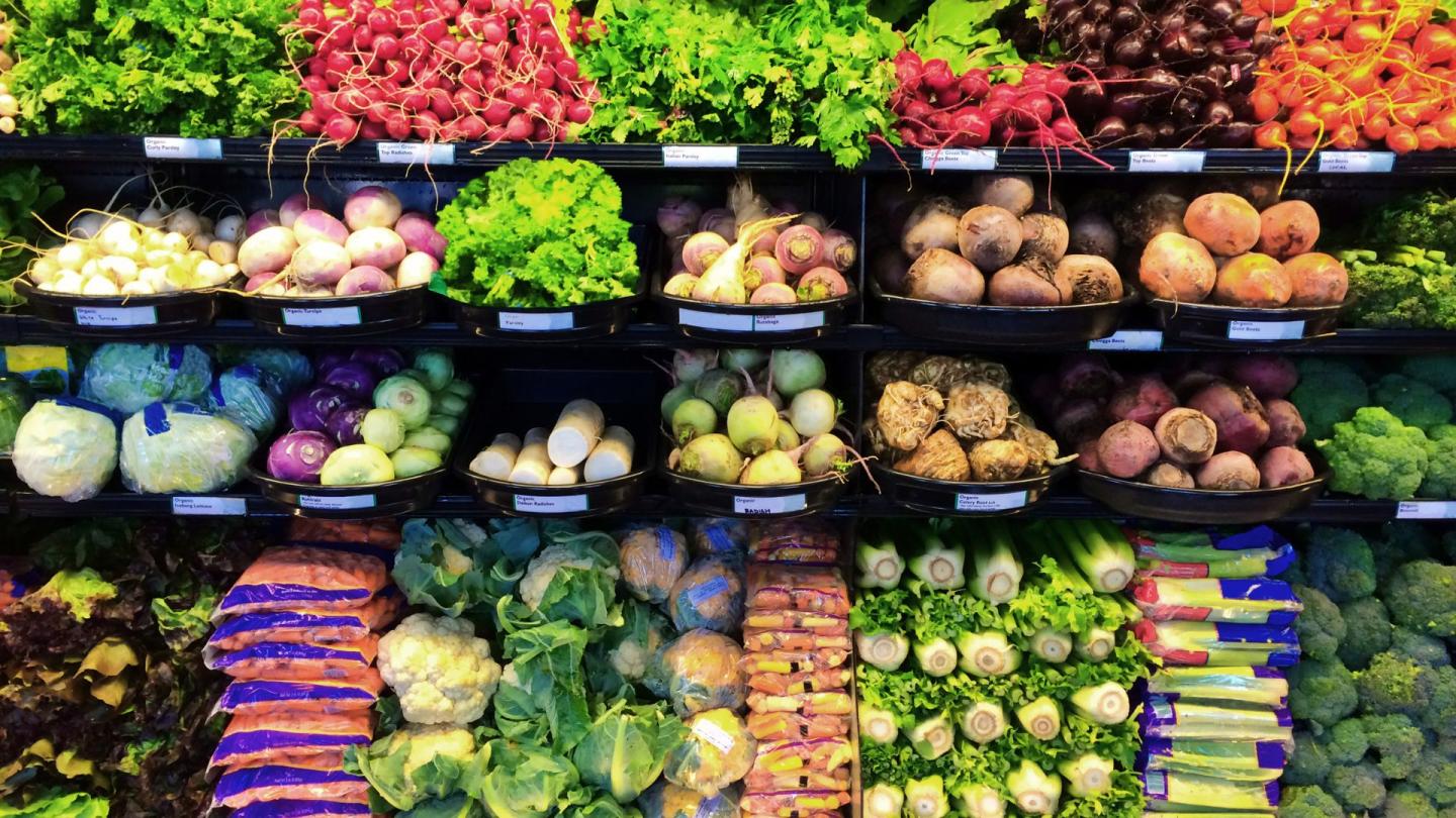 A produce aisle brimming with food at a supermarket