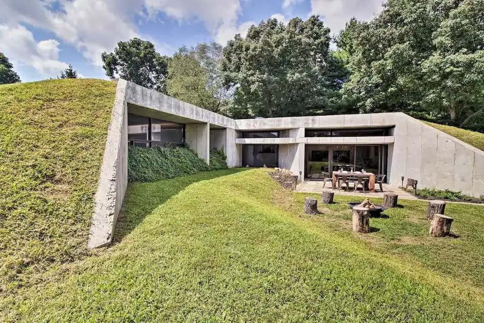 A cement house built into the side of a hill