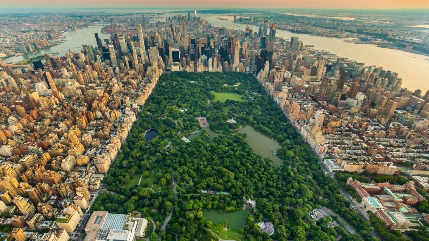 A soaring shot of Central Park centralized with the city of New York wrapped around it