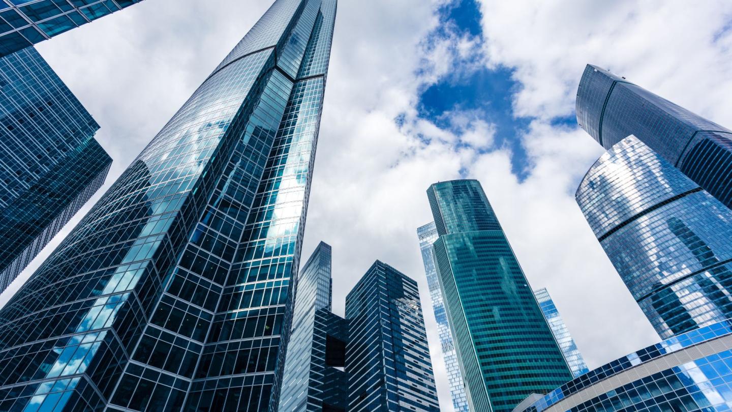 Soaring skyscrapers under a cloudy sky