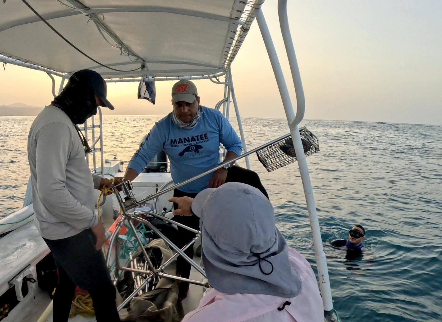 Researchers preparing underwater instruments on their boat