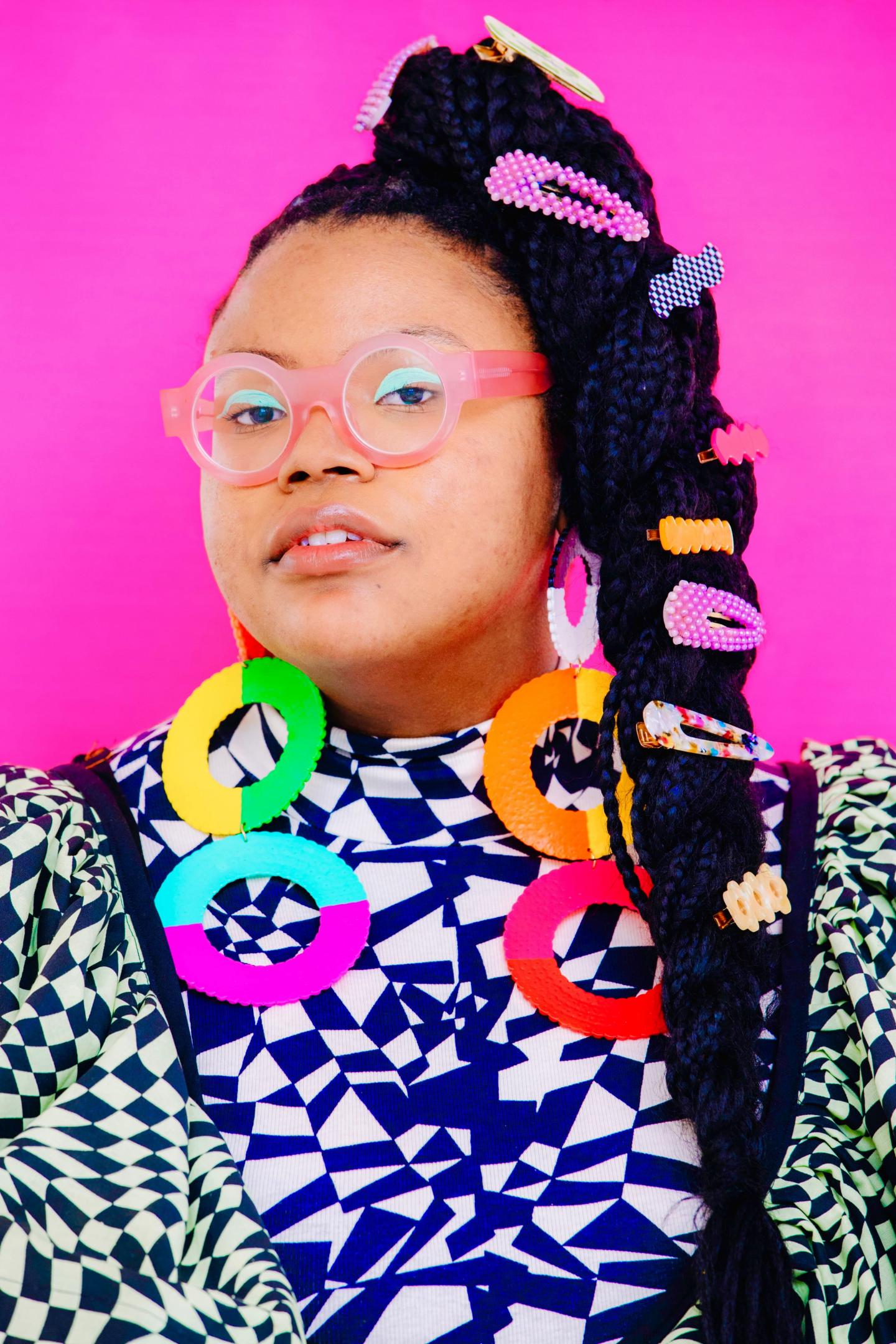 Aaliyah Taylor posing with her colorful earrings