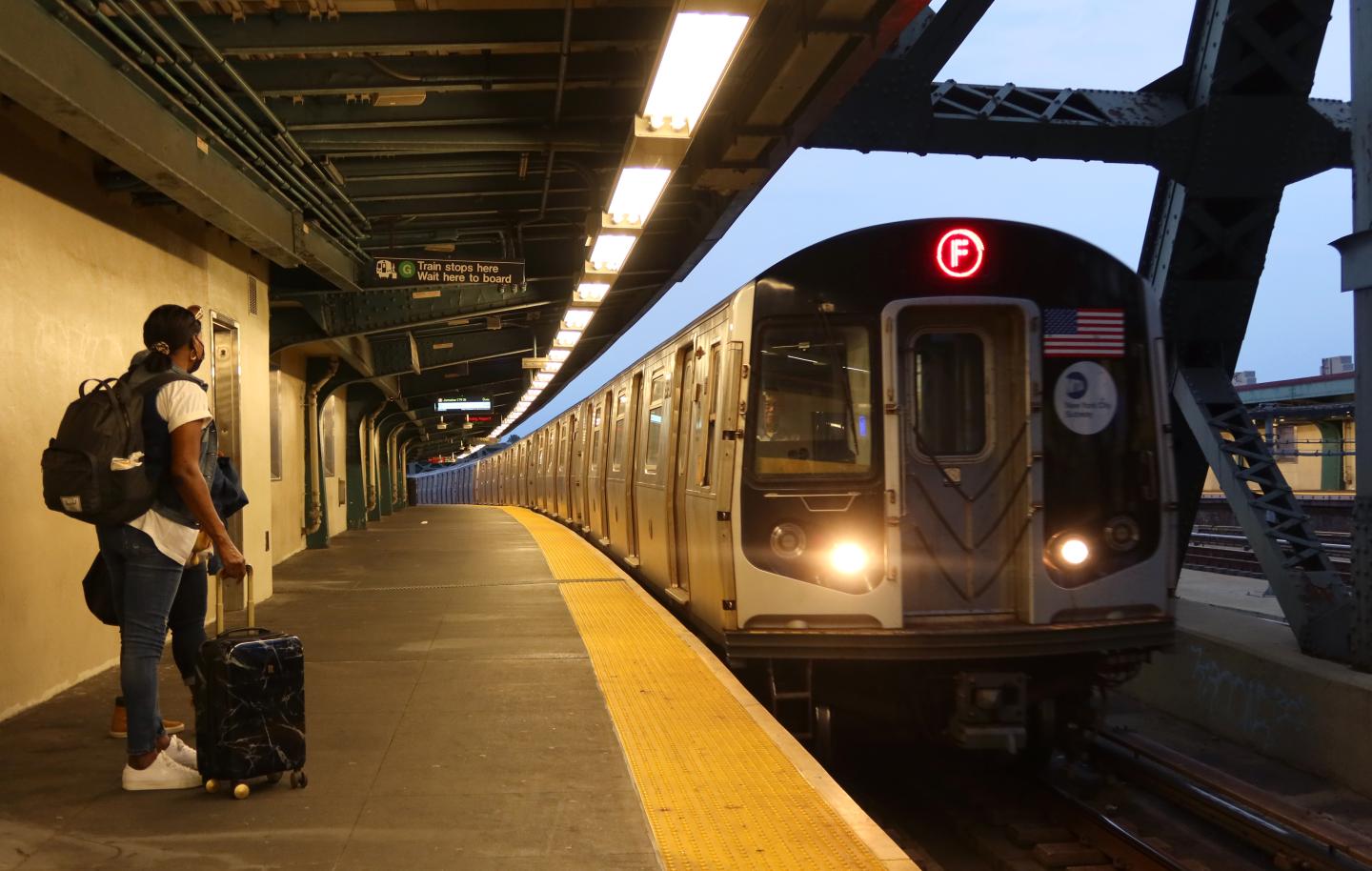 A passenger waits for the New York City subway F train 