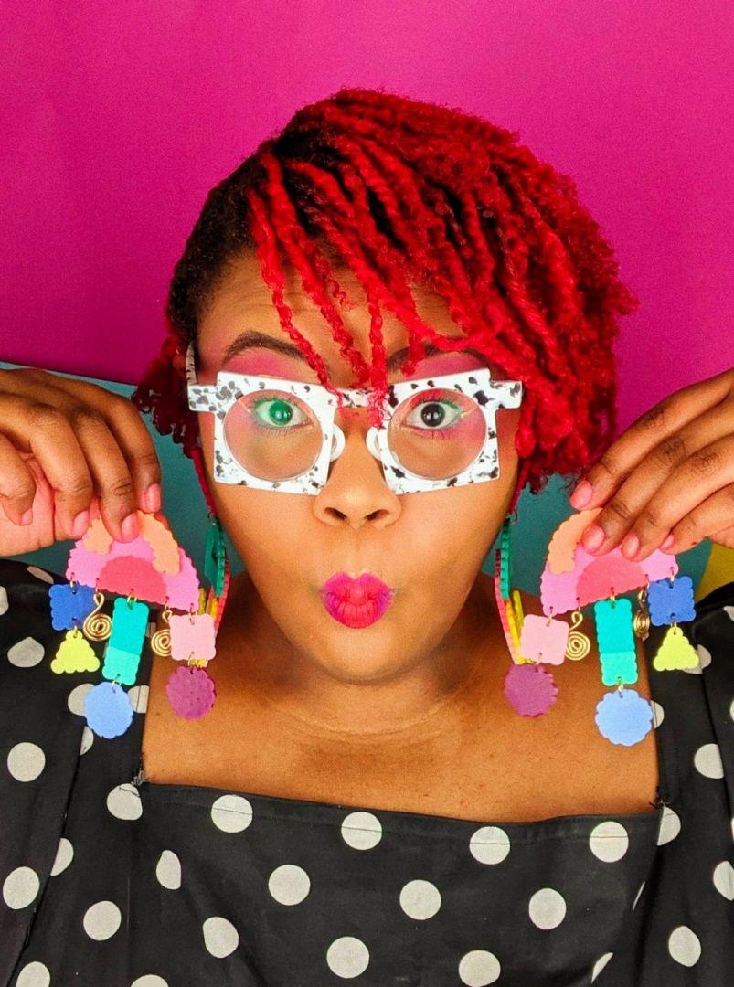 Aaliyah Taylor holds up a pair of her hand-crafted earrings