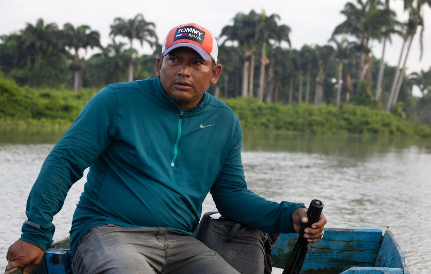 Alberto Dominguez navigates through a channel of mangroves in a small boat