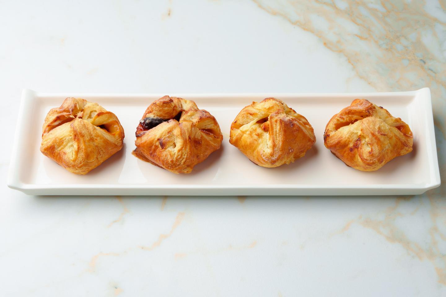 Four croissants on a plate