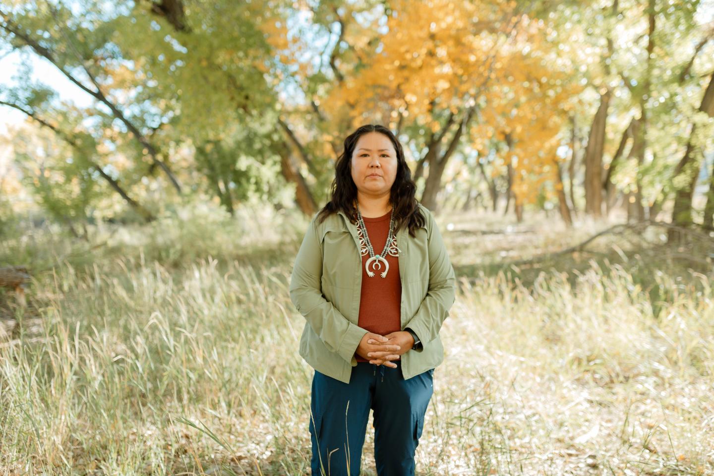 Wendy Atcitty standing in front of trees