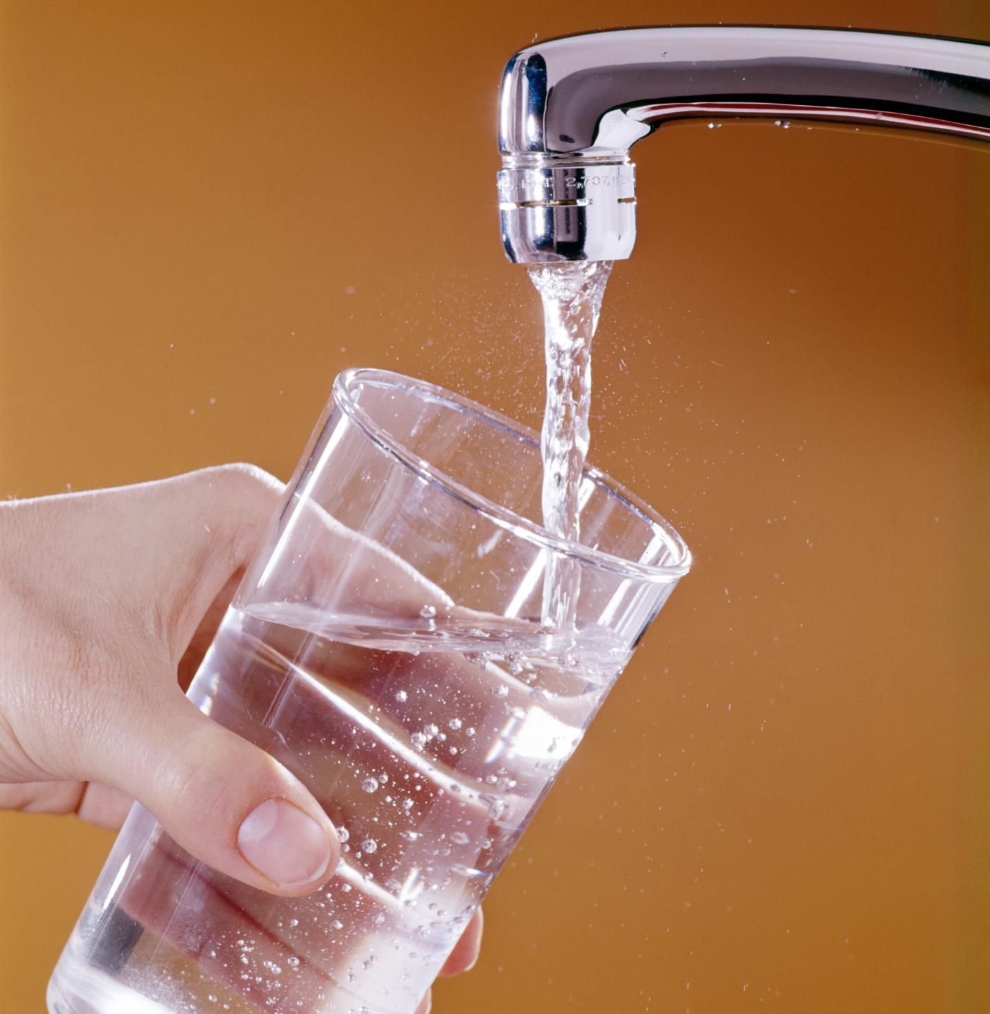 A glass of water being filled