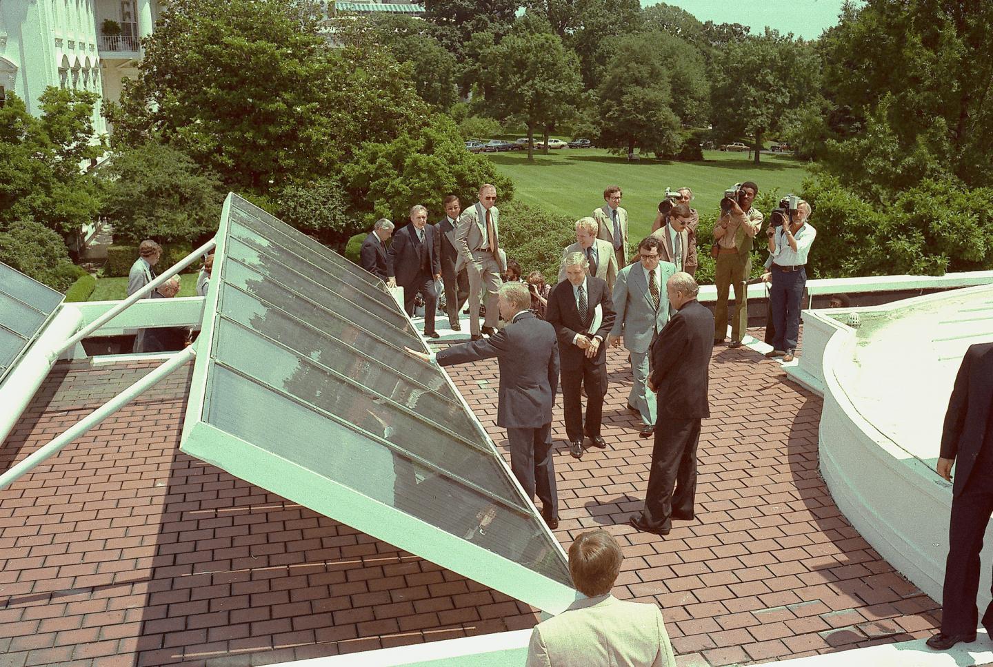 Jimmy Carter on the rooftop of the White House showing off recently installed solar panels