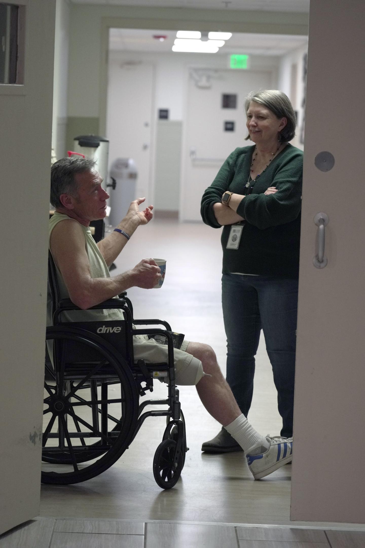 Two people in a hallway in Room in the Inn 