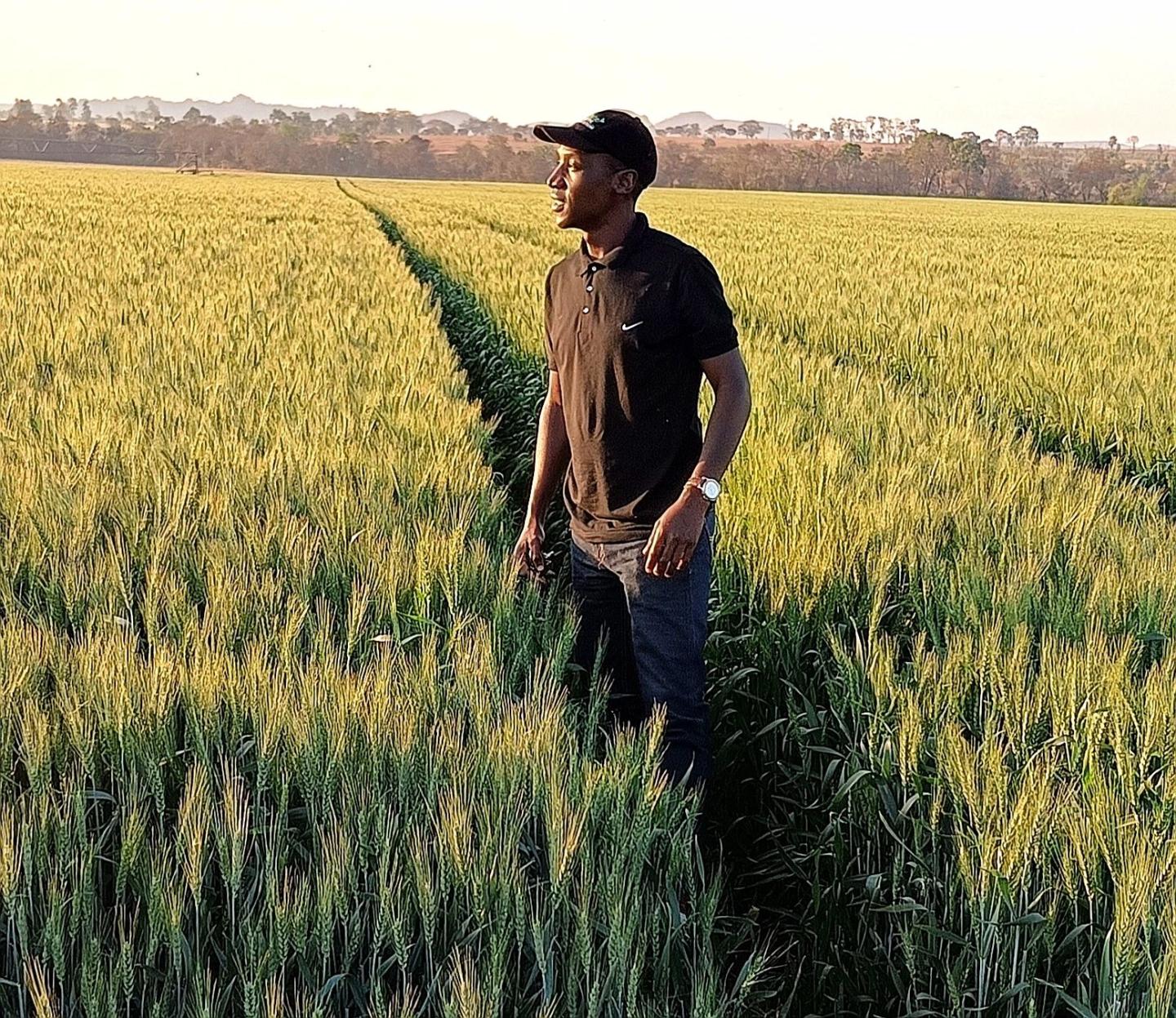  Joshua Zinzombe standing in a field looking into the distance