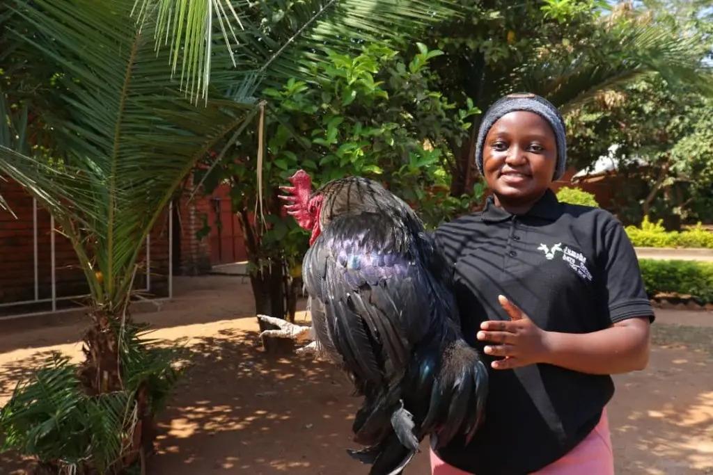 Grace Gondwe holding a chicken