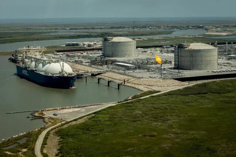 A container ship next to a liquid natural gas terminal