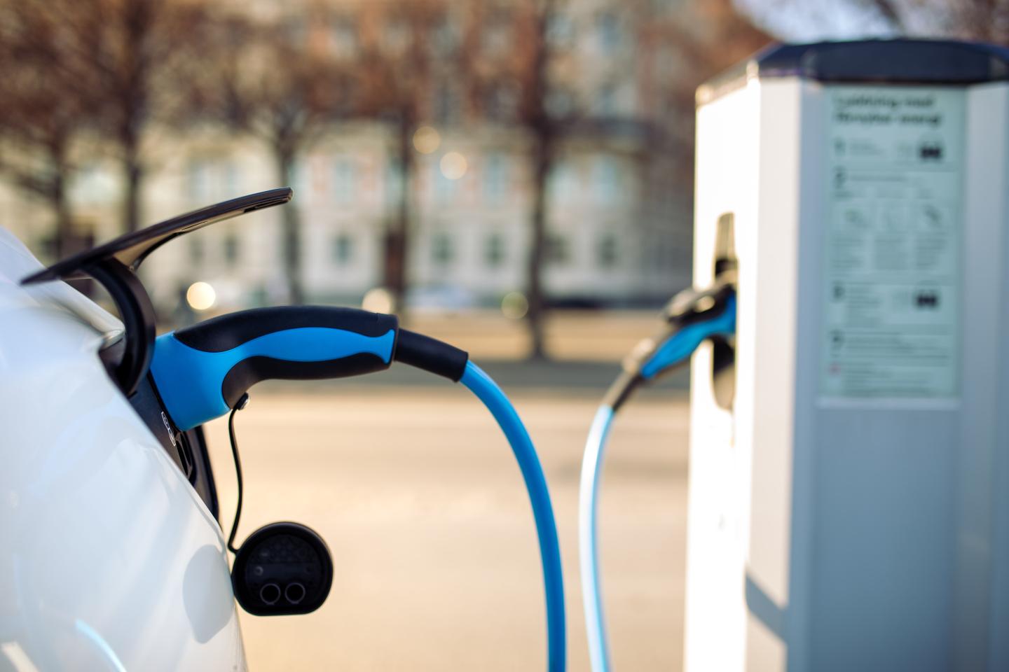 An electric car plugged in to a charger