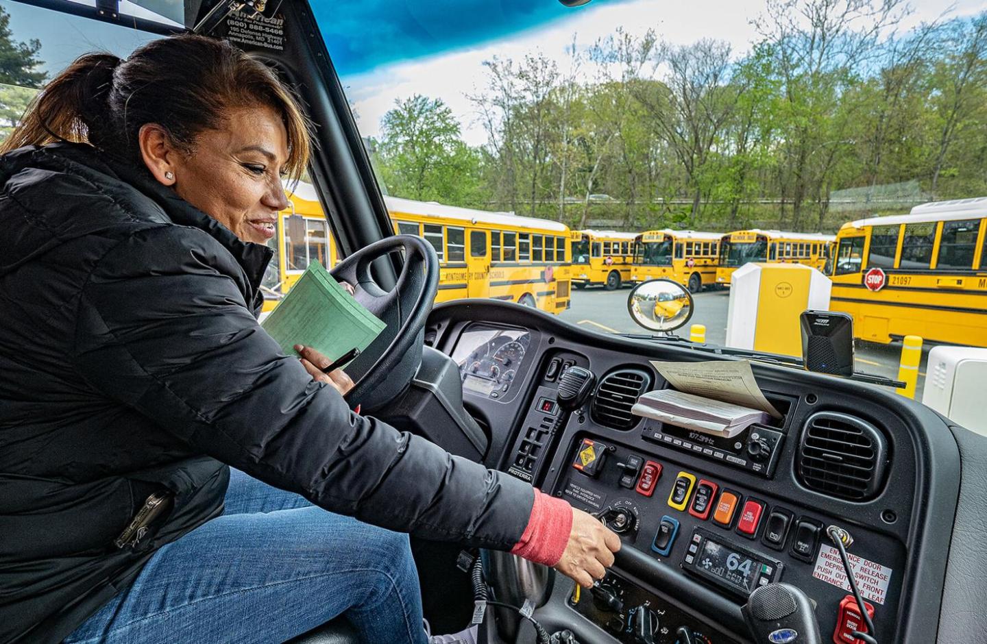 Carmen Cortez starting up the electric school bus she drives