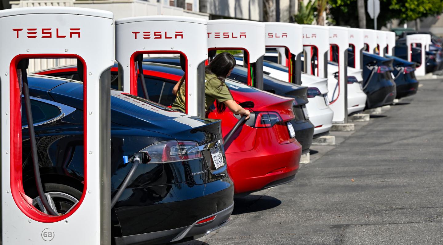A row of Teslas at Tesla chargers