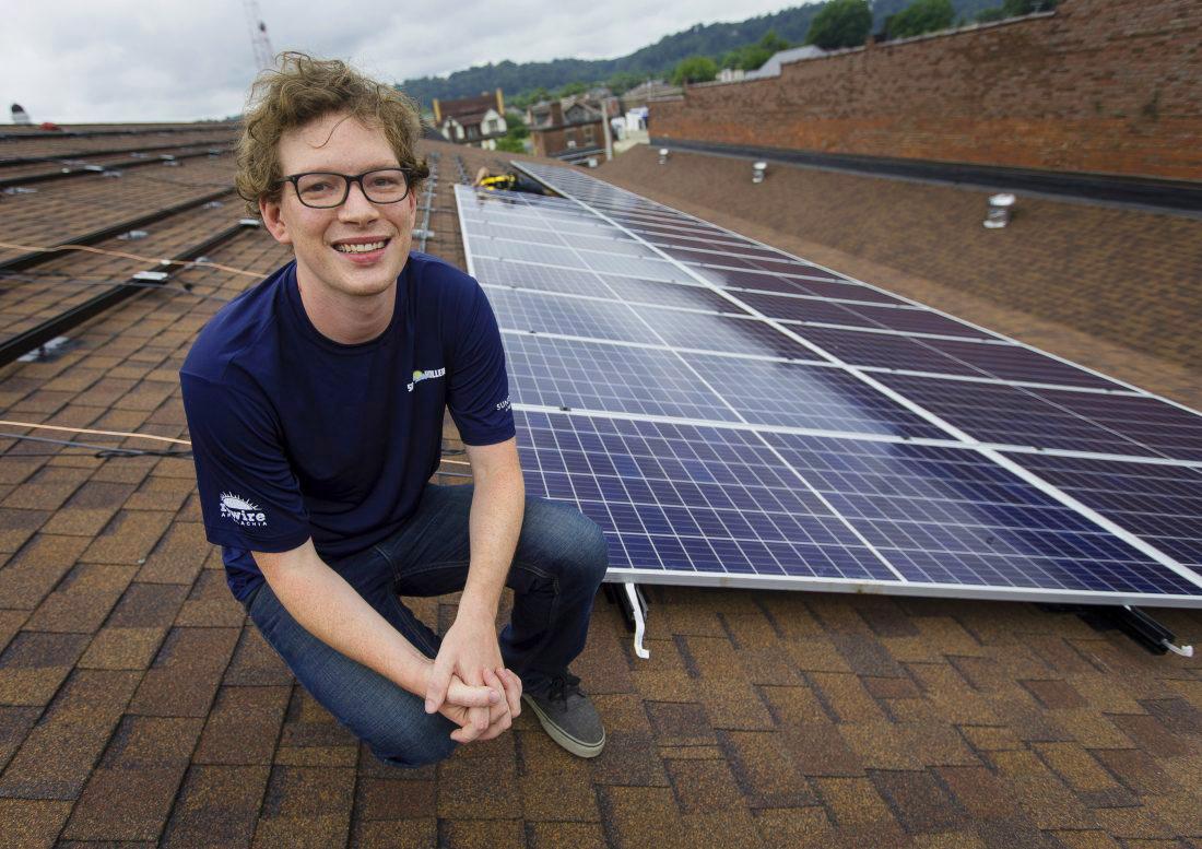 Dan Conant on a rooftop with solar panels