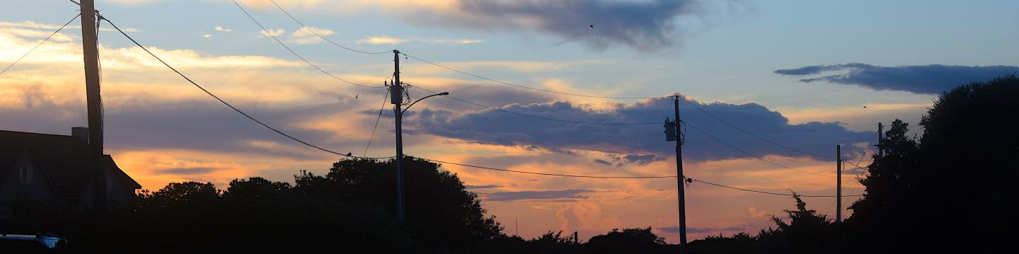 A row of powerlines at sunrise