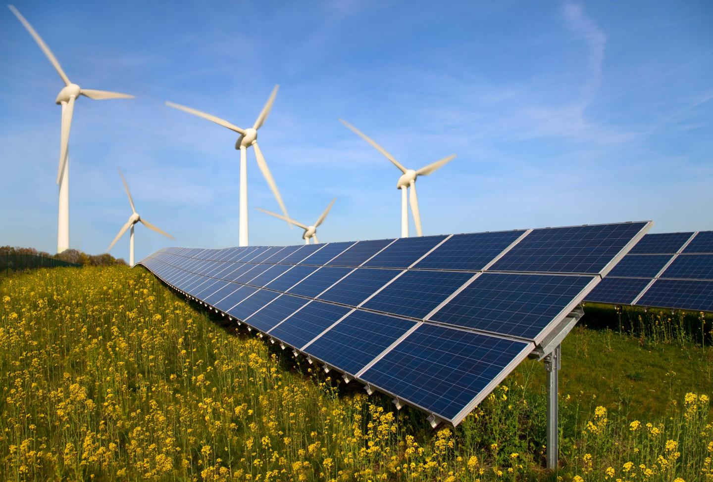 Solar panels and wind turbines in a field