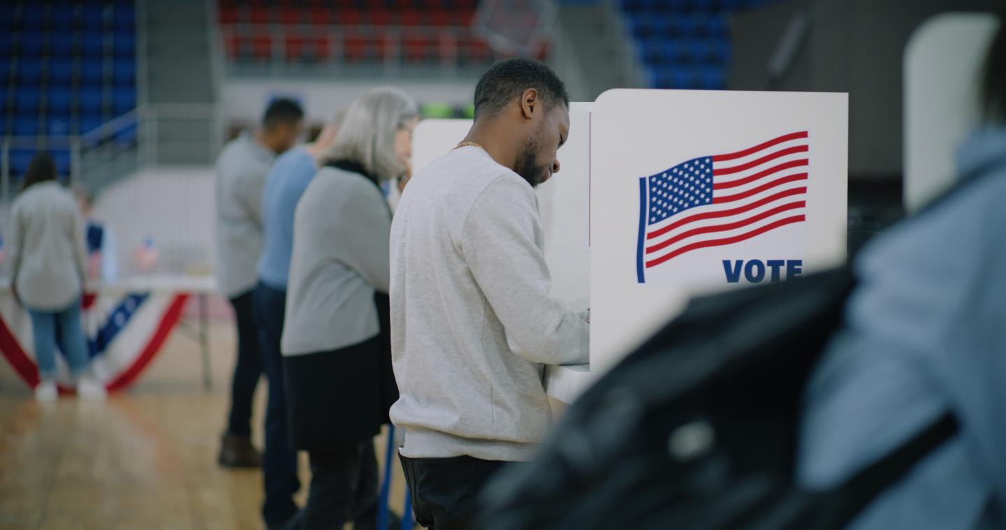 People standing at voting booths