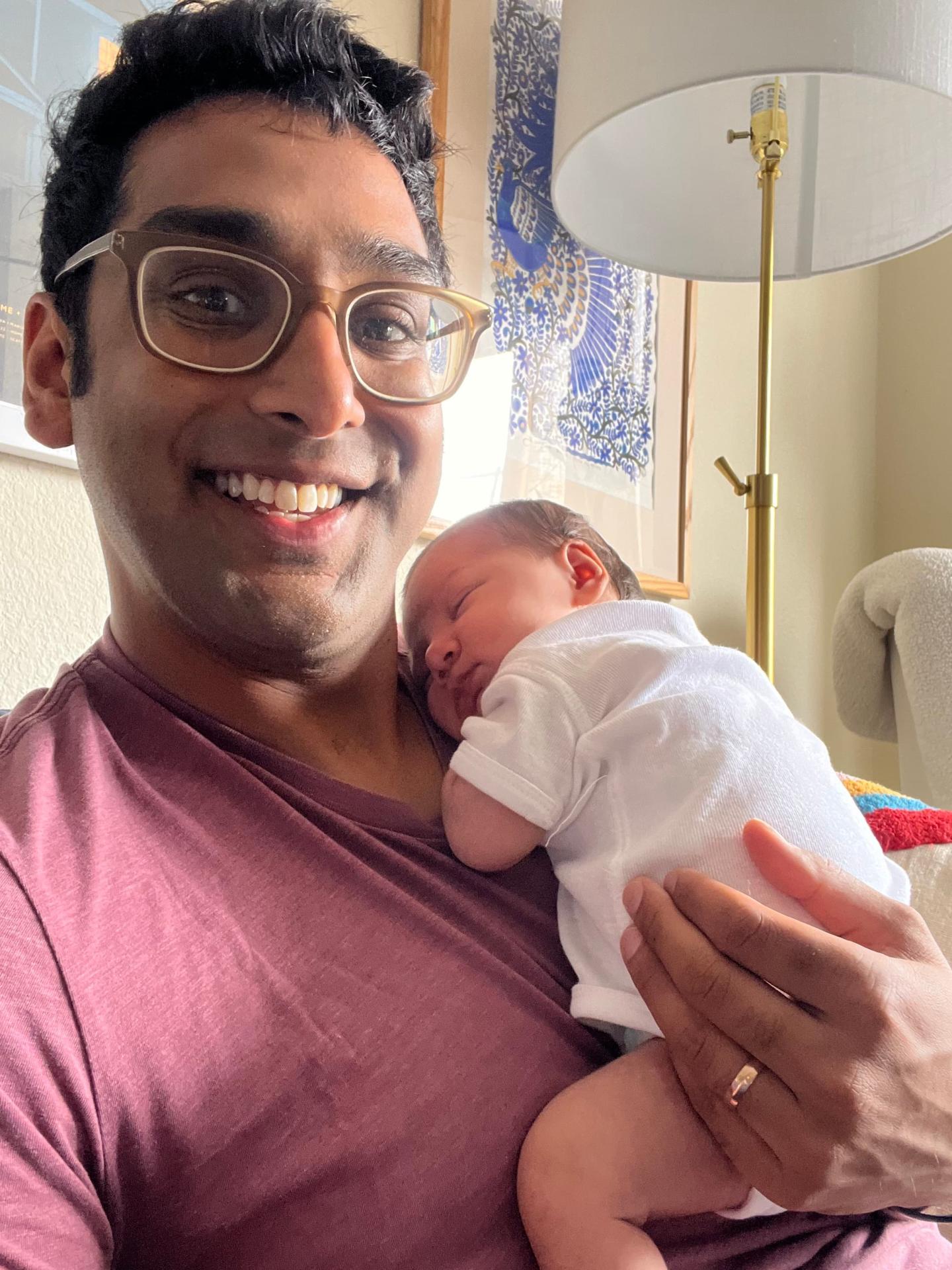 Anuraag Jhawar holding his baby