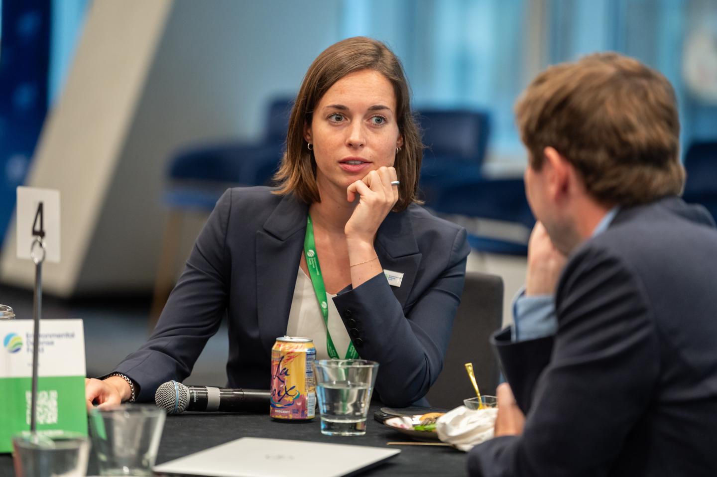 Jane Eisenhardt sitting at a table with a microphone in front of her