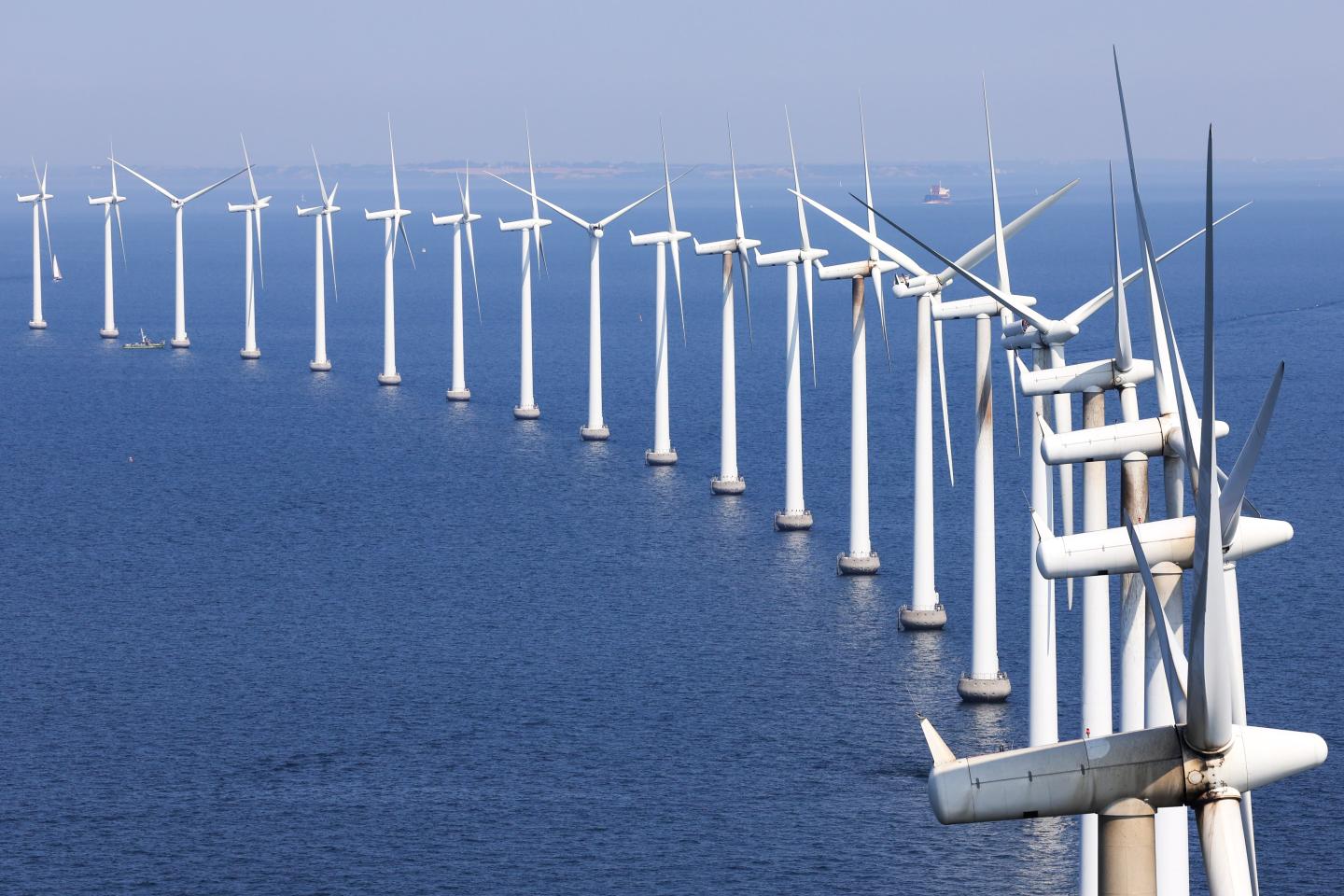 A large row of windmills in the ocean