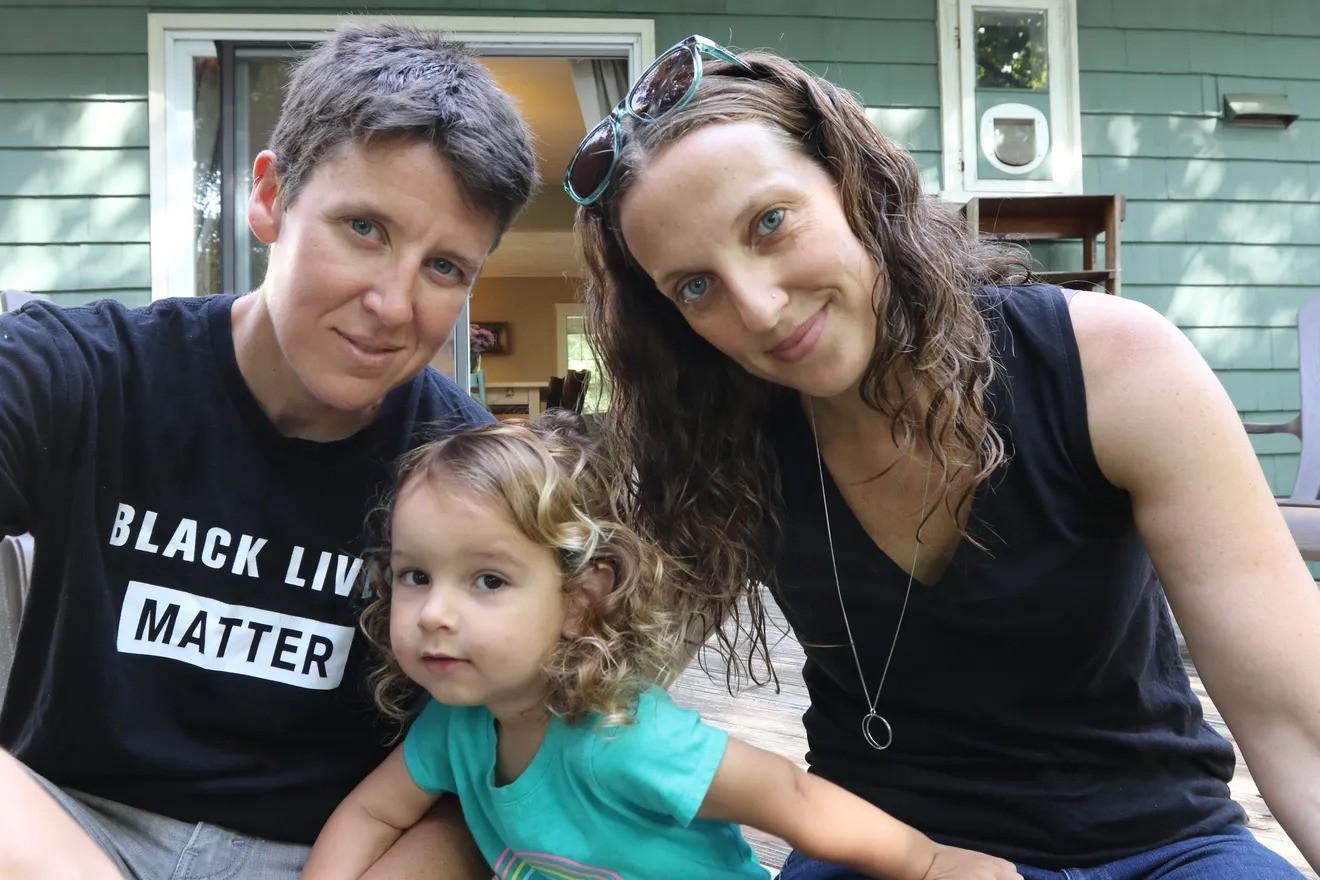 Ellen Tuzzolo and her family outside their home