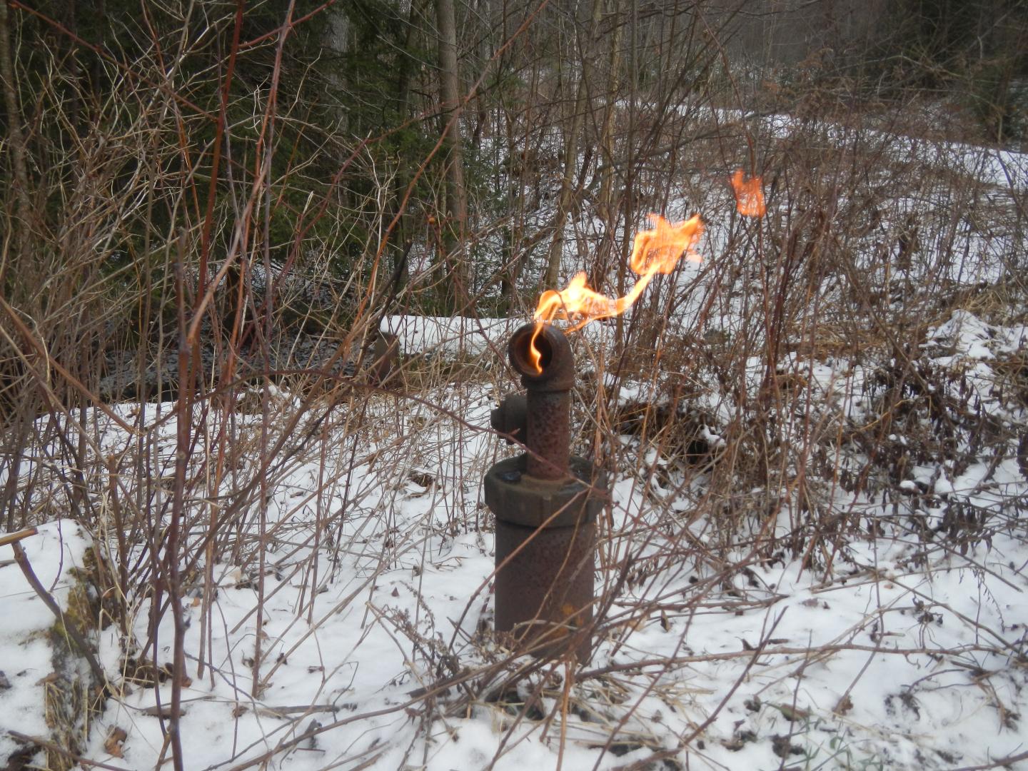 A gas well with a flame coming off of it