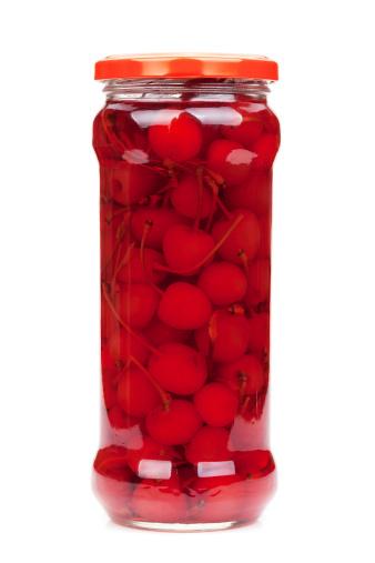 A jar of bright red cherries