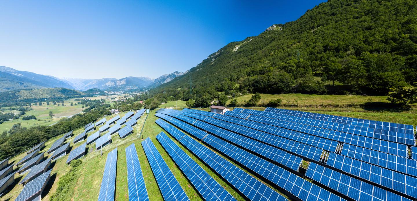 A field with solar panels in mountains in Italy